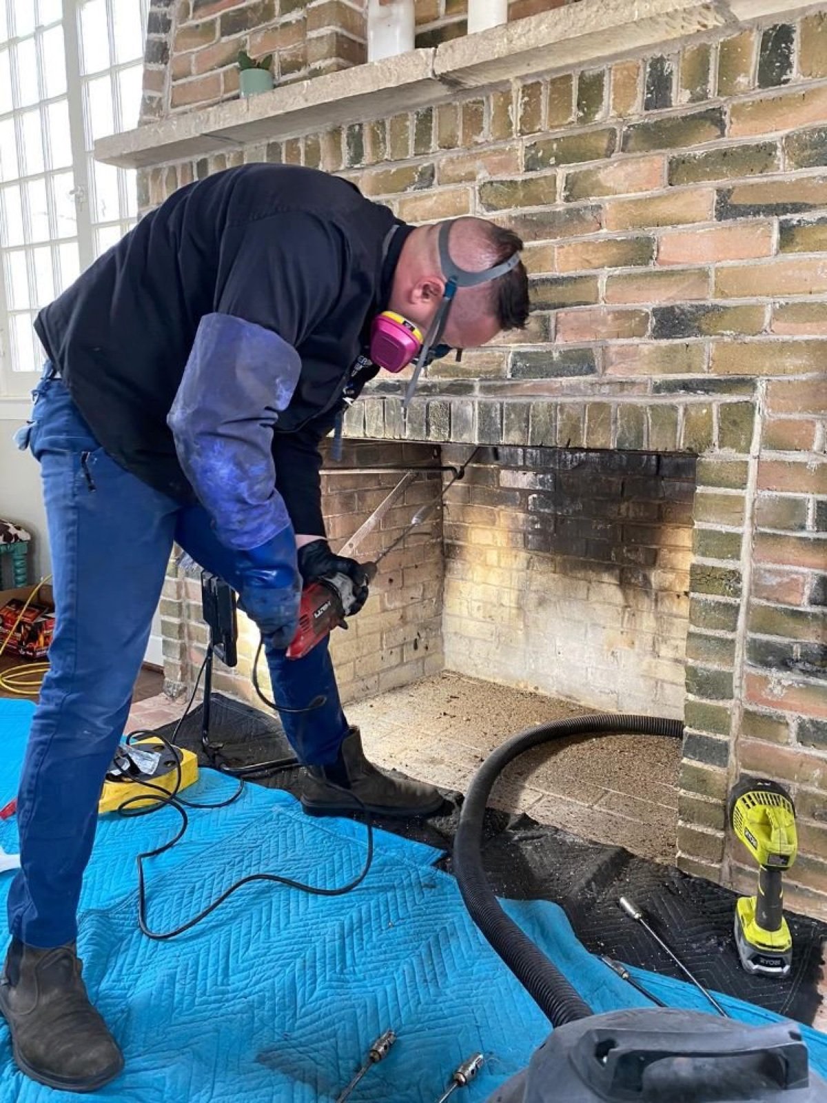 Chimney cleaning technician on a Dallas TX roof
