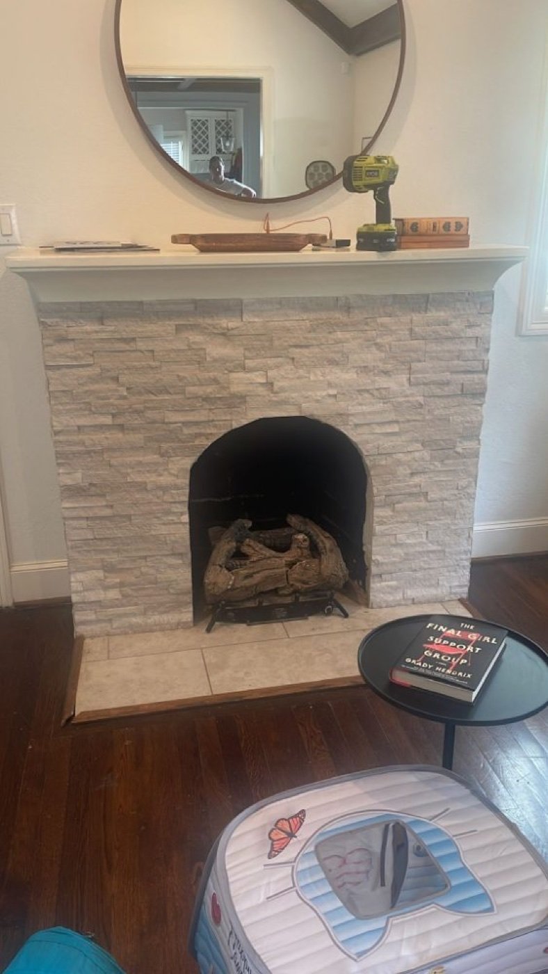 Fireplace surround after repair Dallas TX — beautiful new stone surround installed by Chimney Professionals